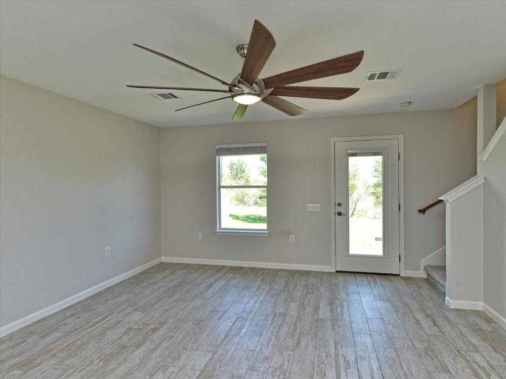 17816 Cutback Drive Manor, TX 78653 - Photo 5 of 28 a view of an empty room with wooden floor and a window