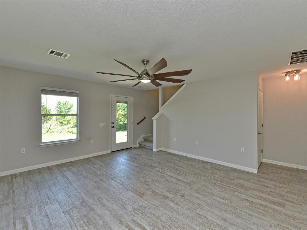 17816 Cutback Drive Manor, TX 78653 - Photo 7 of 28 a view of empty room with wooden floor and fan