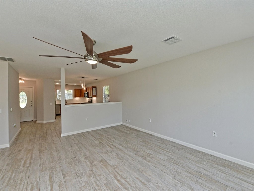 17816 Cutback Drive Manor, TX 78653 - Photo 8 of 28 a view of a livingroom with a ceiling fan and wooden floor