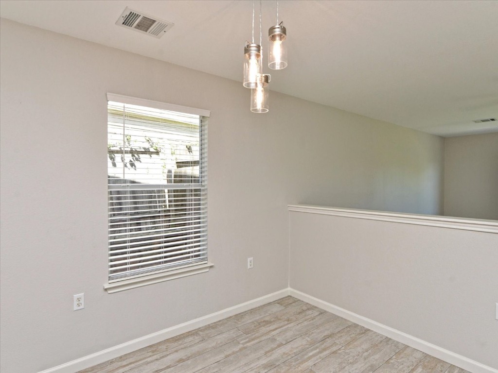 17816 Cutback Drive Manor, TX 78653 - Photo 9 of 28 wooden floor in an empty room with a window