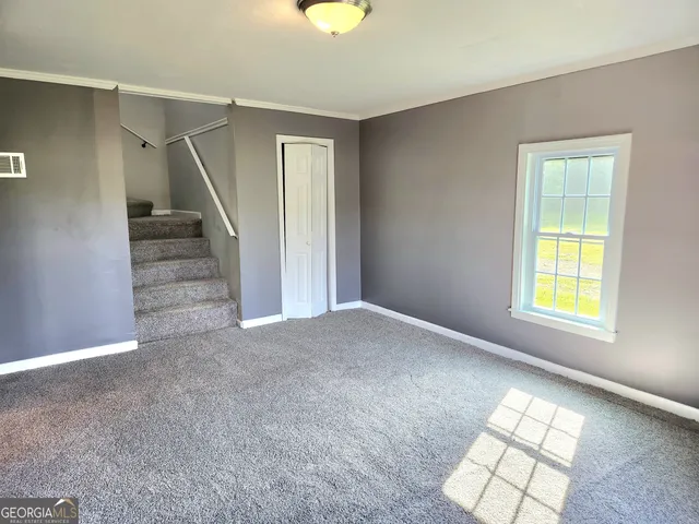 a view of an empty room and a window