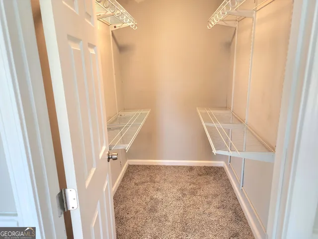 a view of staircase with white walls and a window