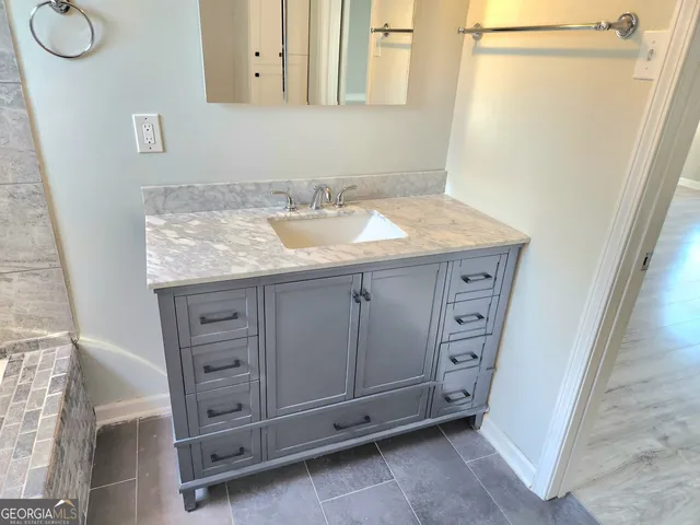 a bathroom with a sink a vanity and a mirror