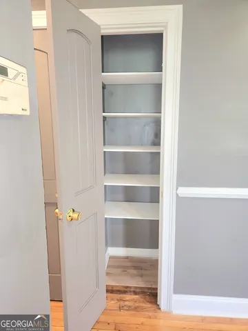 a view of walk in closet with empty racks