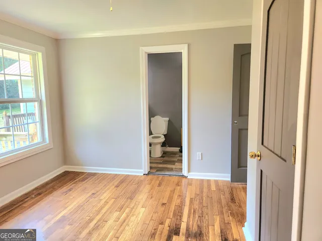 an empty room with windows and closet