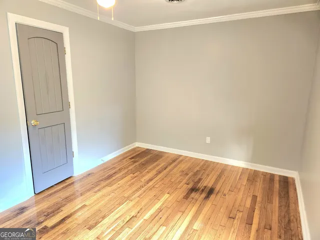 a view of a room with wooden floor and closet
