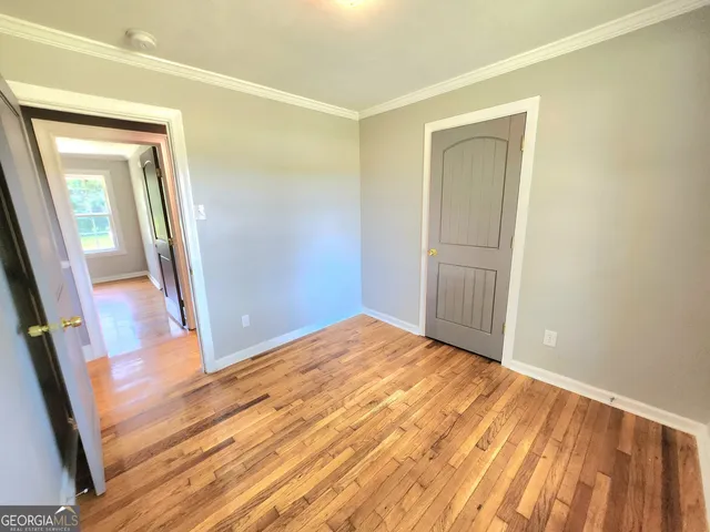 wooden floor in an empty room with a mirror