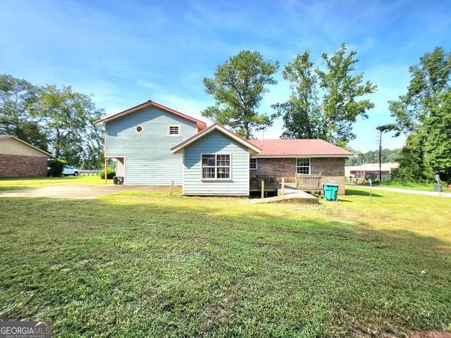 a front view of house with yard and outdoor seating