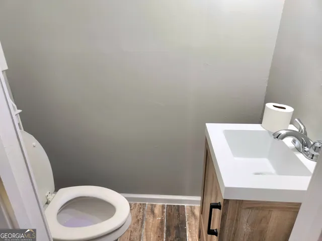 a bathroom with a sink a toilet and a mirror