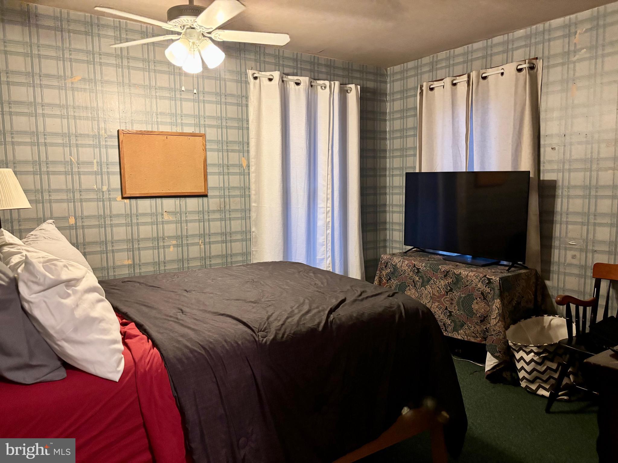 133 Black Street Howard, PA 16841 - Photo 13 of 26 a bedroom with a bed and a flat screen tv