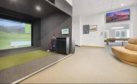 a living room with furniture and large windows