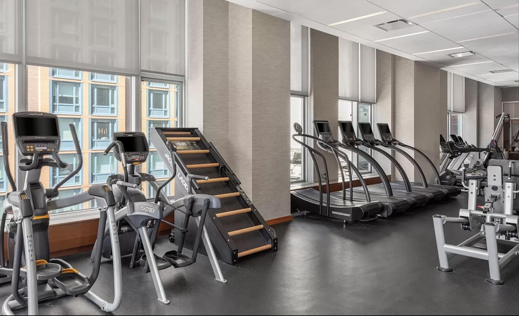 8 Spruce Street, Unit 36T Manhattan, NY 10038 - Photo 16 of 19 a room with gym equipment and a large window