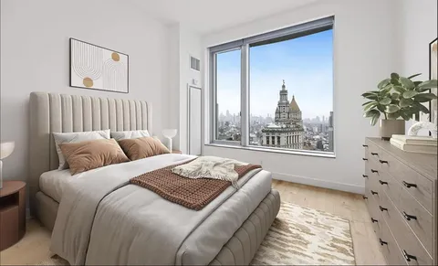 a bed sitting in a bedroom next to a window