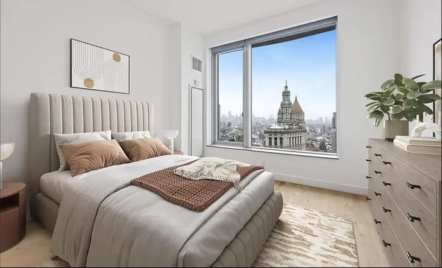 a bed sitting in a bedroom next to a window