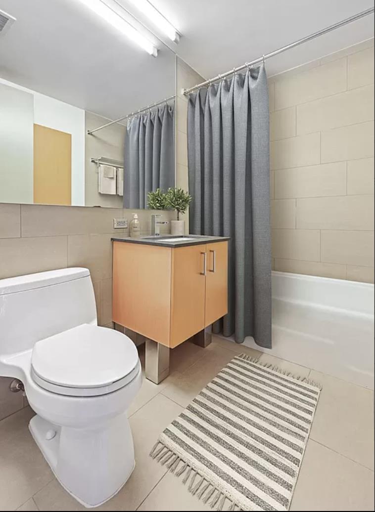 8 Spruce Street, Unit 36T Manhattan, NY 10038 - Photo 6 of 19 a bathroom with a sink toilet and shower