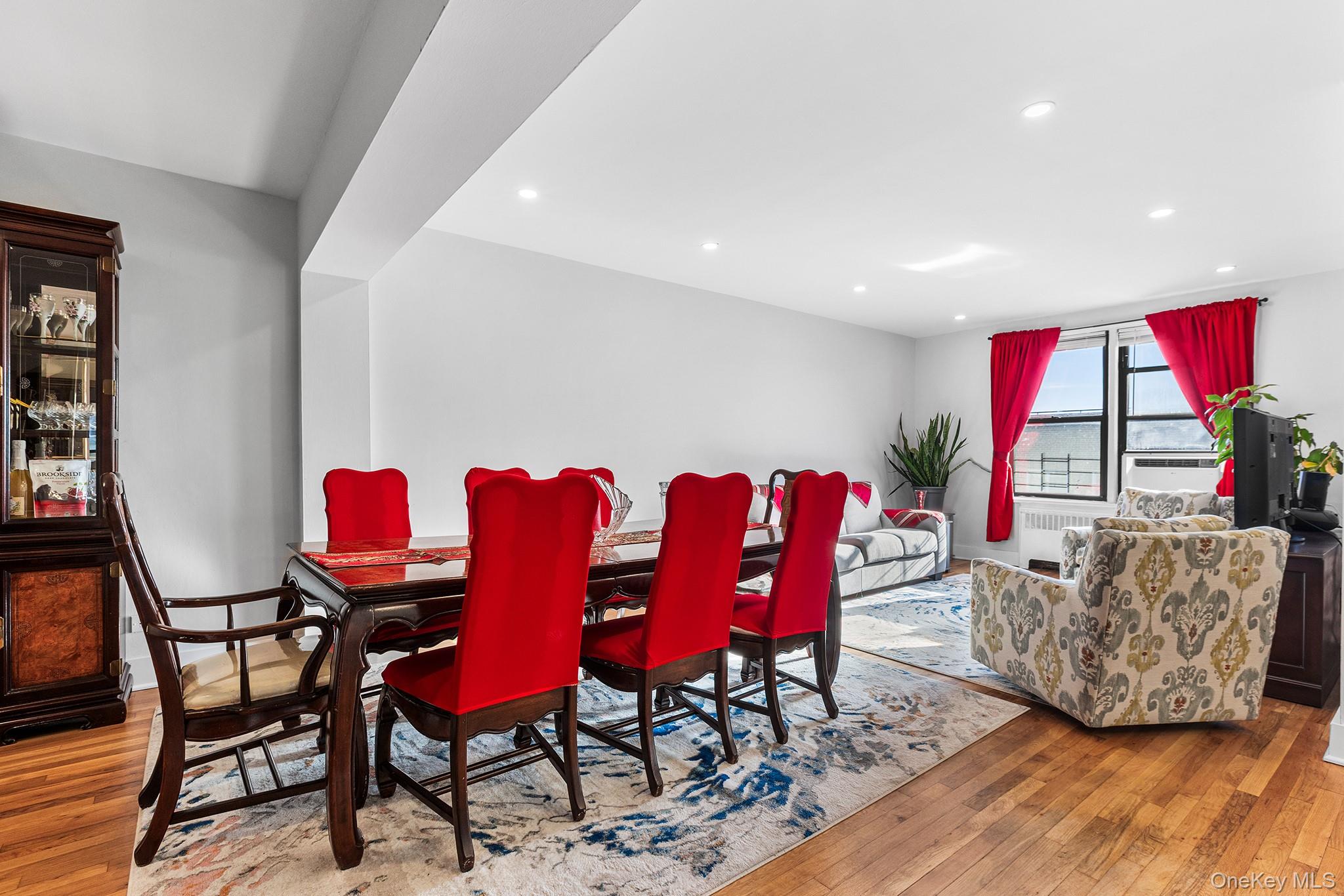 525 West 235th Street, Unit 7E Bronx, NY 10463 - Photo 6 of 14 a living room with furniture a rug and a wooden floor