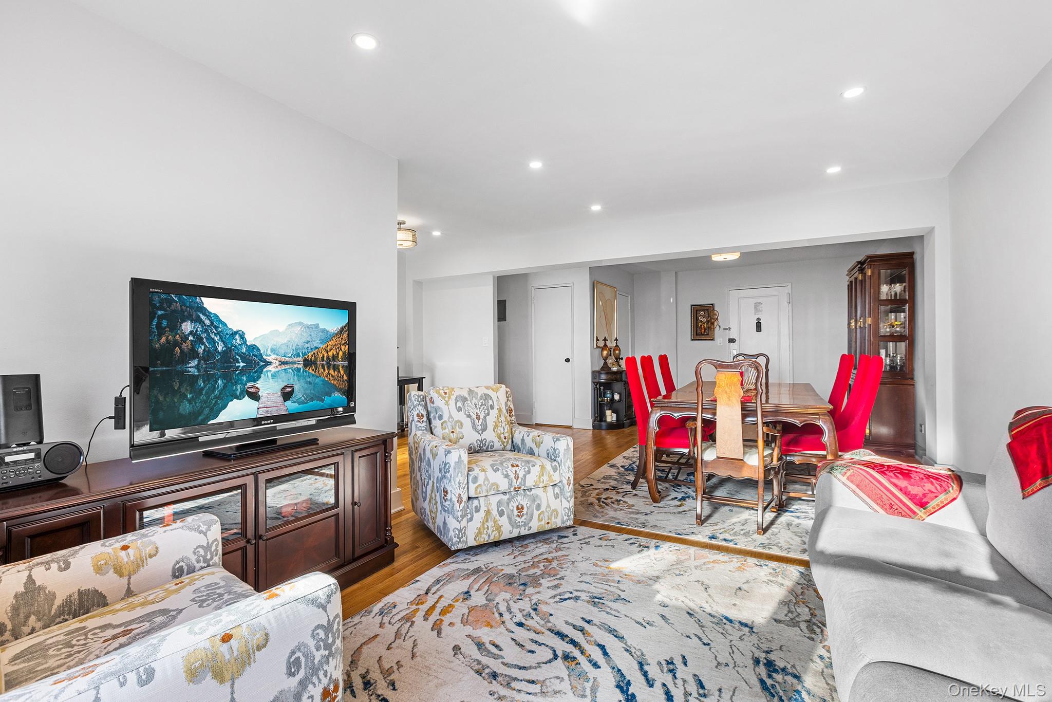 525 West 235th Street, Unit 7E Bronx, NY 10463 - Photo 7 of 14 a living room with furniture and a flat screen tv