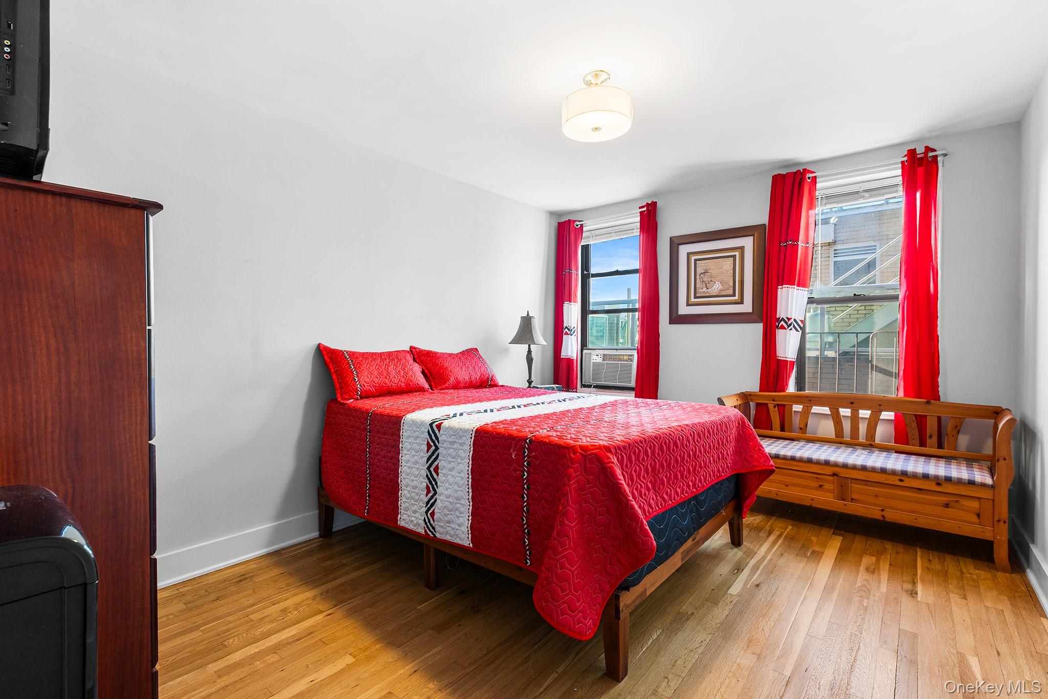 525 West 235th Street, Unit 7E Bronx, NY 10463 - Photo 9 of 14 a bedroom with a bed and a window