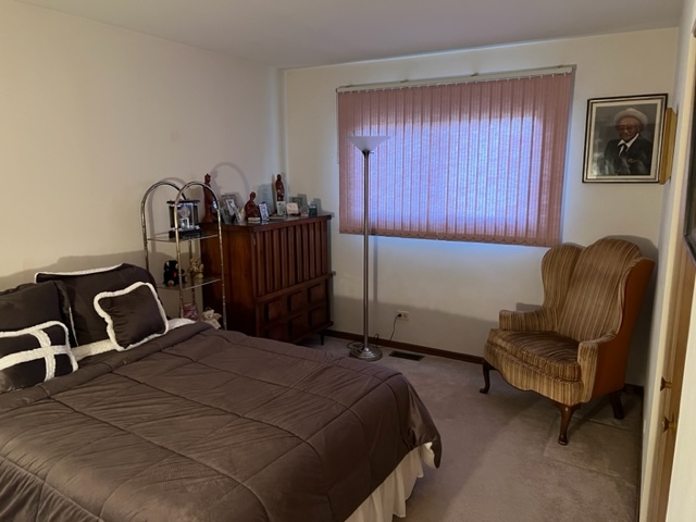 30 Red Barn Road Matteson, IL 60443 - Photo 16 of 34 a bedroom with a bed and a chair