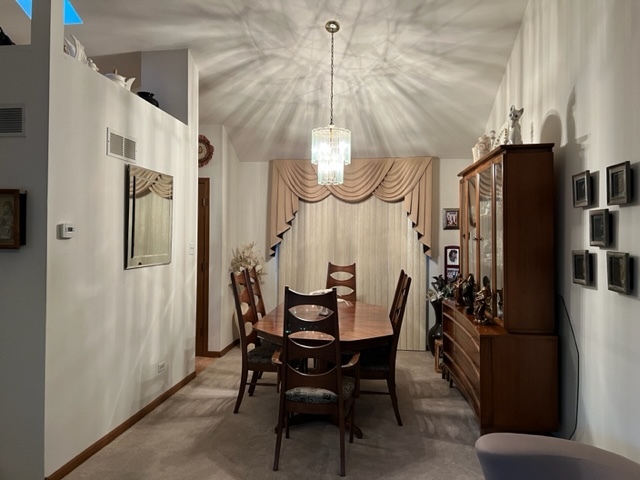 30 Red Barn Road Matteson, IL 60443 - Photo 6 of 34 a dining room with furniture a chandelier and wooden floor