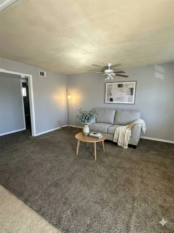 a living room with furniture and a rug