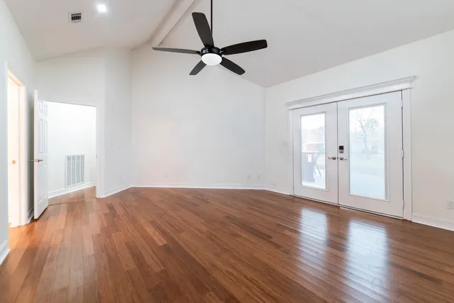 wooden floor in an empty room with a window