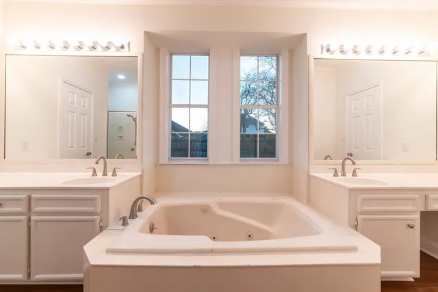 a white bath tub sitting next to a white sink