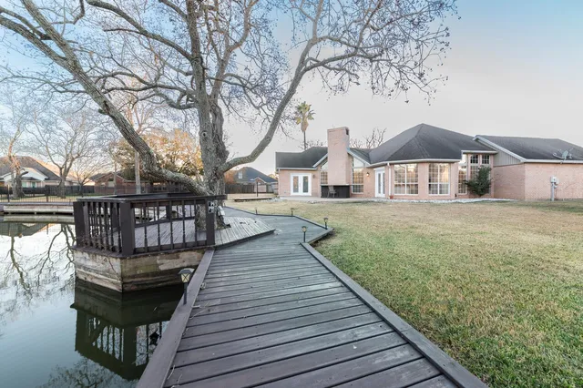 a view of a wooden chairs and table on the wooden deck
