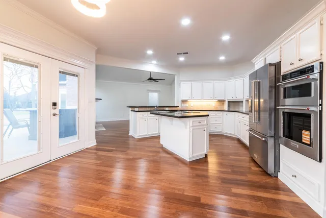 an open kitchen with kitchen island and stainless steel appliances