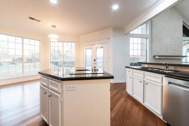 a kitchen with granite countertop a sink and a stove