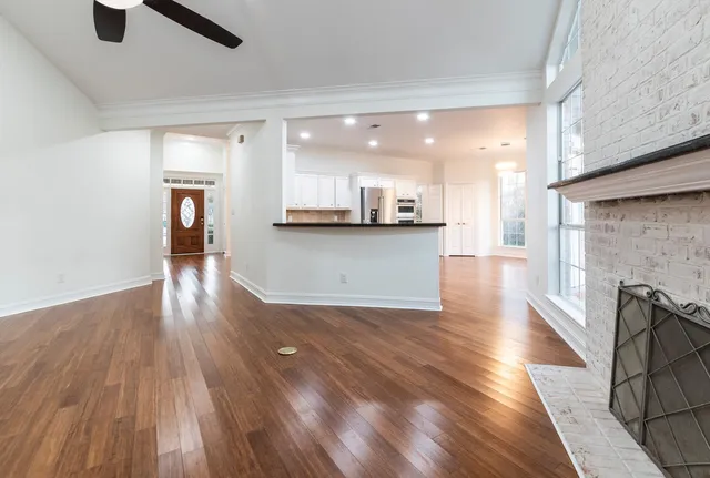 a view of a kitchen with furniture and wooden floor