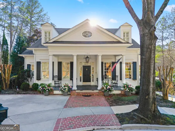 a front view of a house with garden