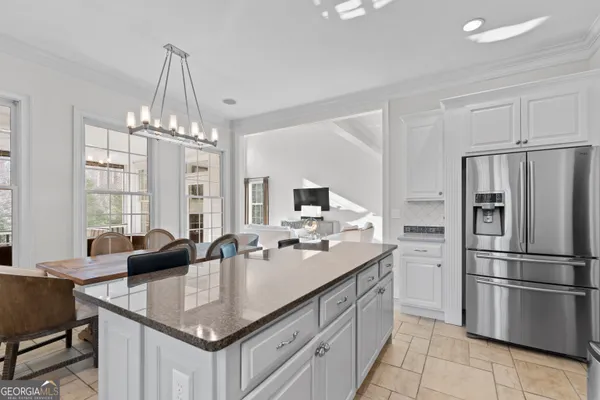 a kitchen with a center island a sink cabinets and stainless steel appliances