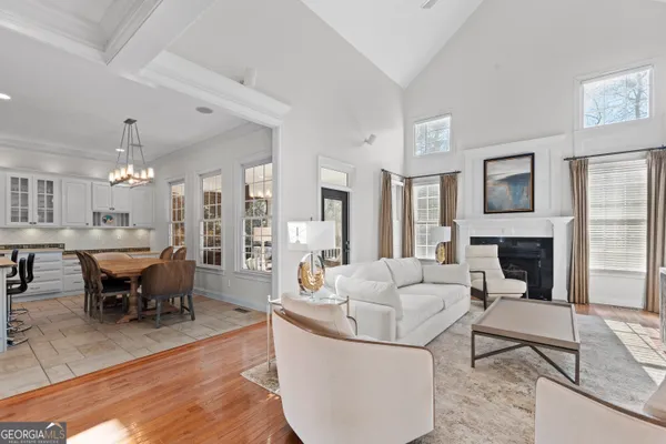 a living room with furniture a fireplace and a table