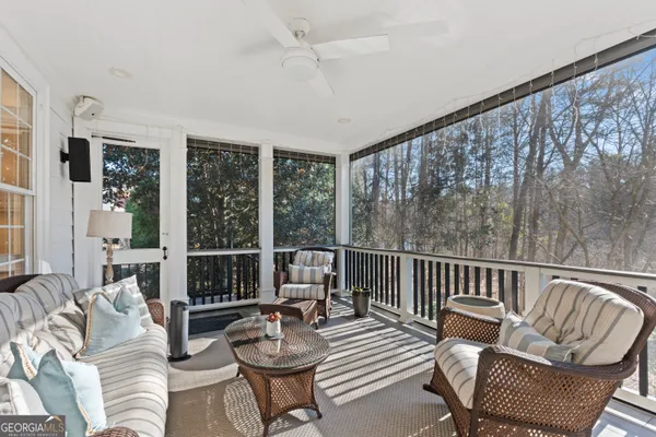 a balcony with furniture and wooden floor