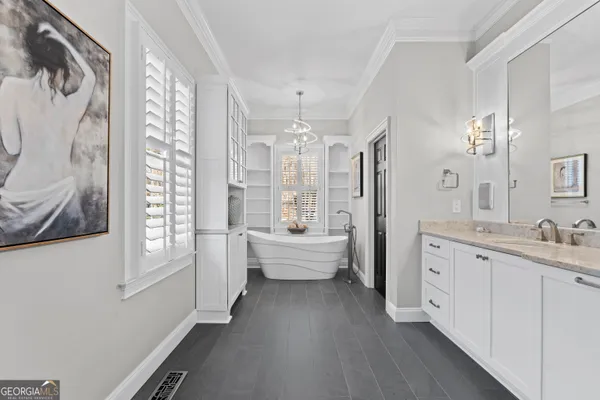 a large white kitchen with a large window