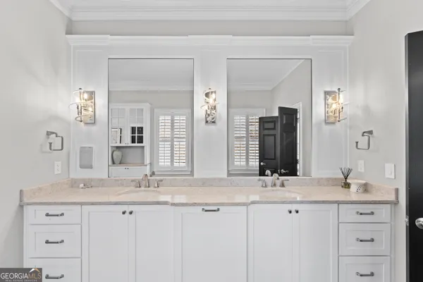 a bathroom with double sink and a mirror
