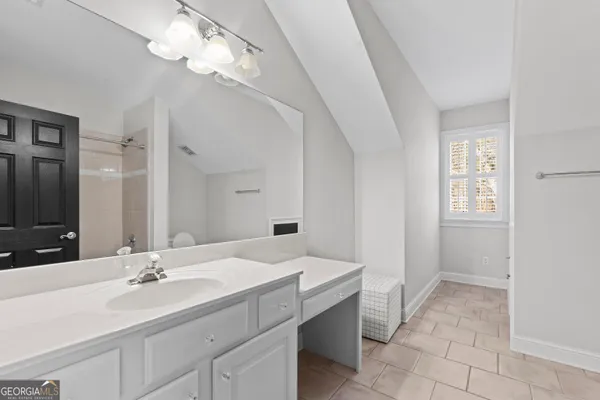 a bathroom with a double vanity sink a mirror and a shower
