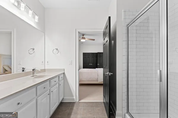 a bathroom with double sink and a mirror