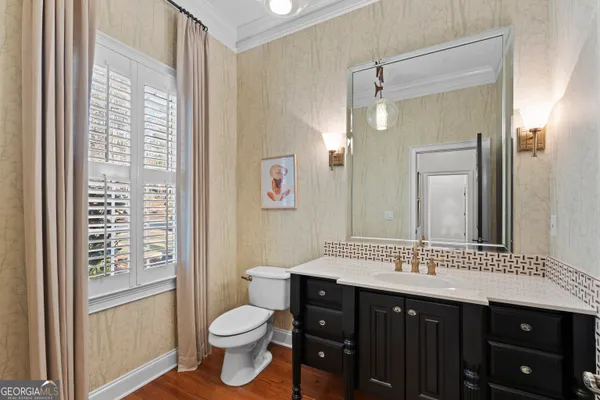 a bathroom with a double vanity sink toilet and a mirror