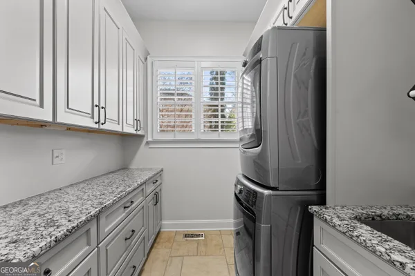 a kitchen with granite countertop a refrigerator and a stove