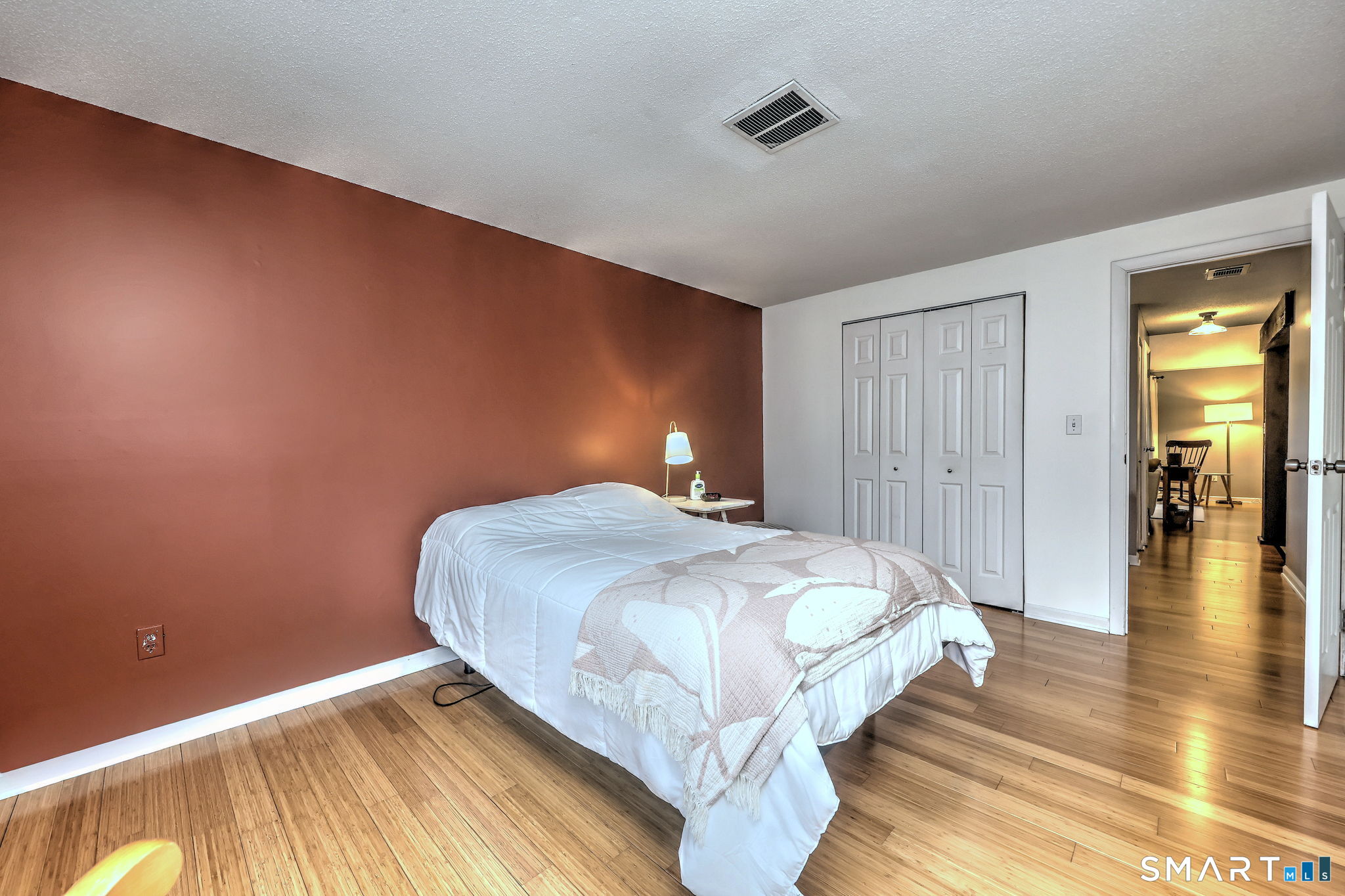 55 Dowd Avenue, Unit 22 Canton, CT 06019 - Photo 10 of 29 a bedroom with a bed and wooden floor