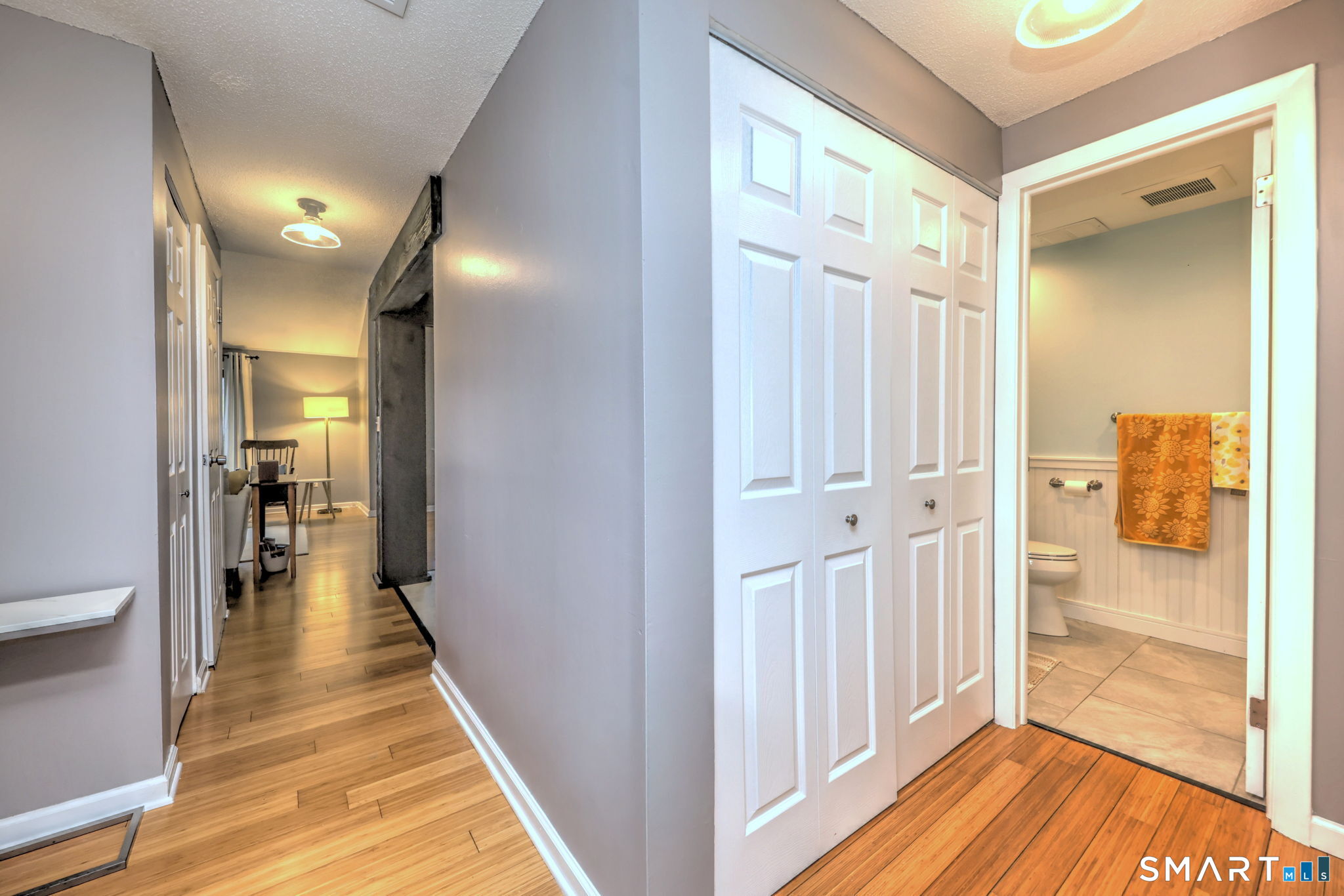 55 Dowd Avenue, Unit 22 Canton, CT 06019 - Photo 11 of 29 a view of a hallway with wooden floor and a bathroom