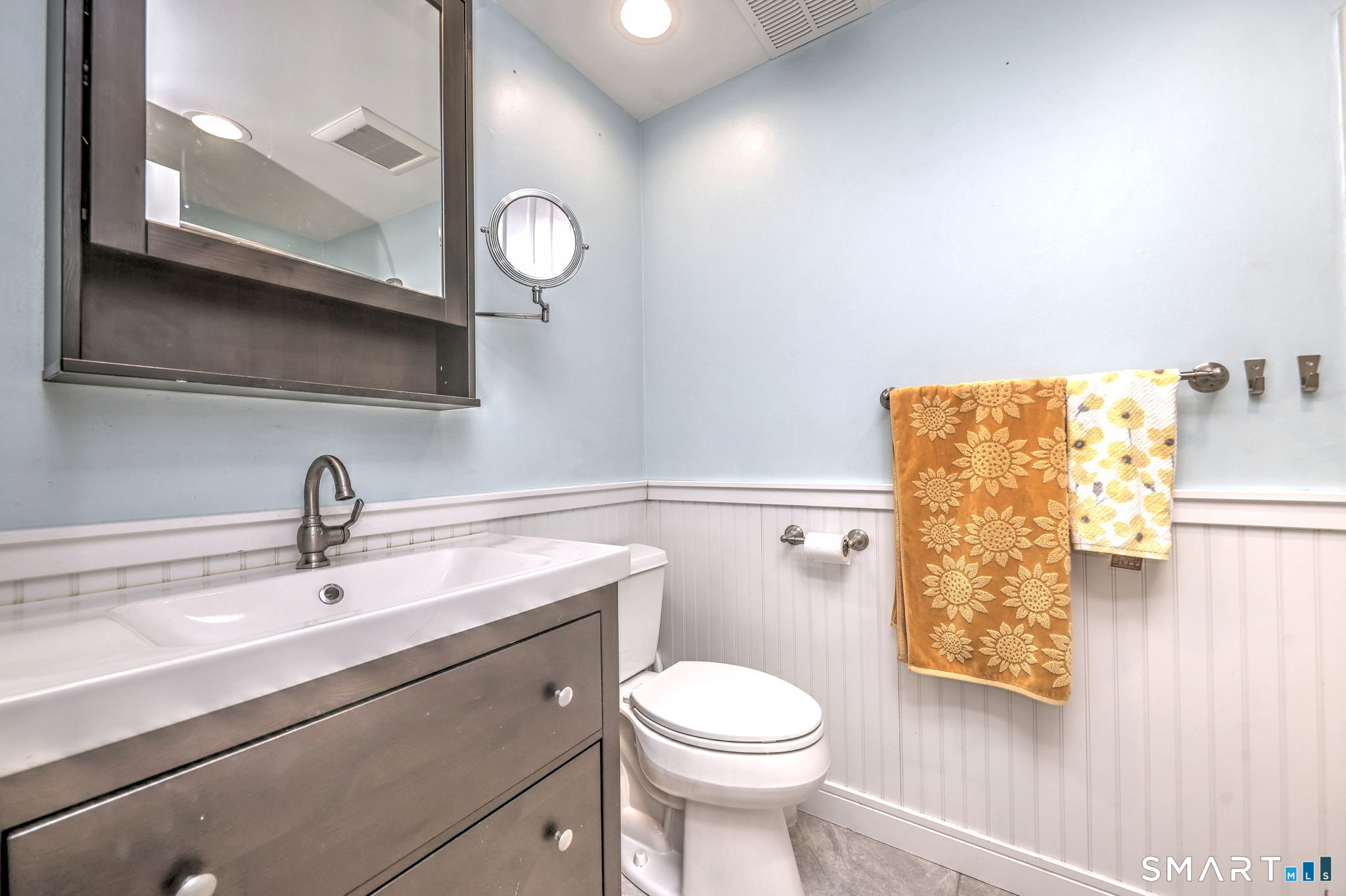 55 Dowd Avenue, Unit 22 Canton, CT 06019 - Photo 13 of 29 a bathroom with a toilet a sink and mirror