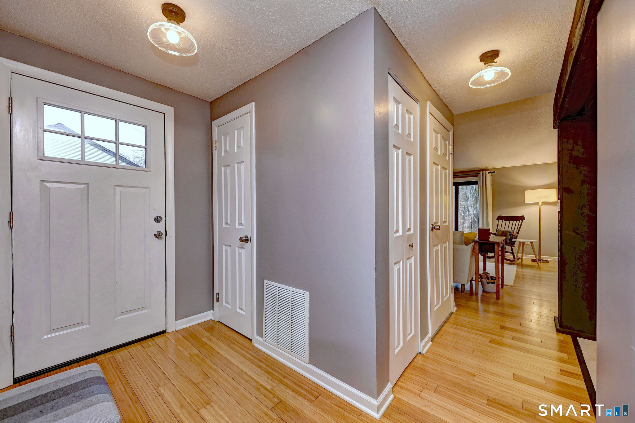 55 Dowd Avenue, Unit 22 Canton, CT 06019 - Photo 25 of 29 a view of a hallway with wooden floor and staircase