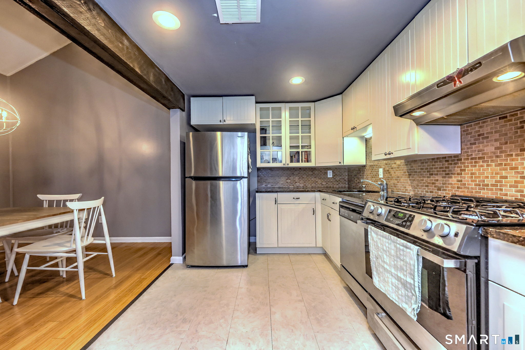 55 Dowd Avenue, Unit 22 Canton, CT 06019 - Photo 26 of 29 a kitchen with stainless steel appliances granite countertop a stove a refrigerator and a sink