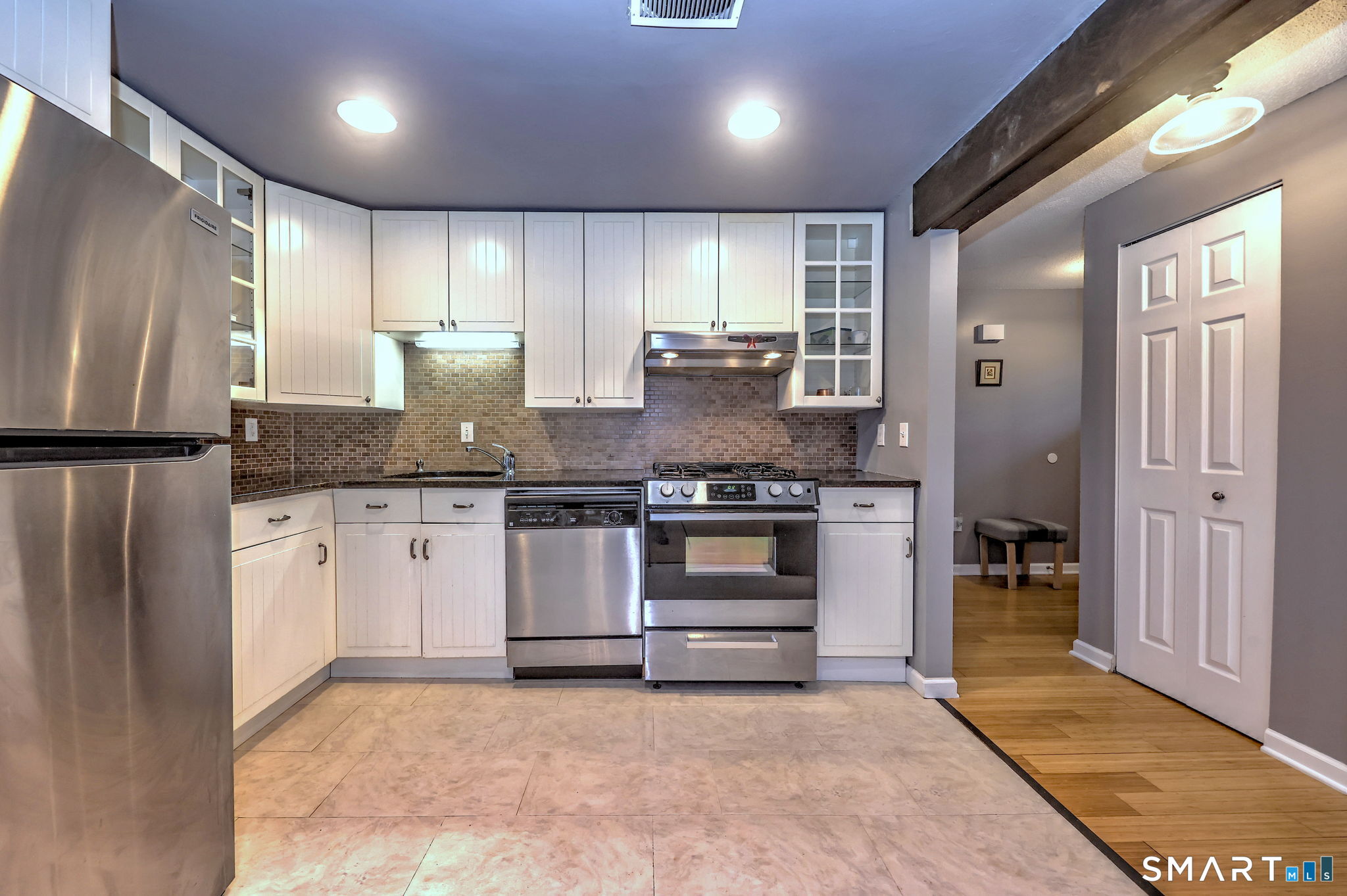 55 Dowd Avenue, Unit 22 Canton, CT 06019 - Photo 8 of 29 a kitchen with granite countertop a stove and cabinets