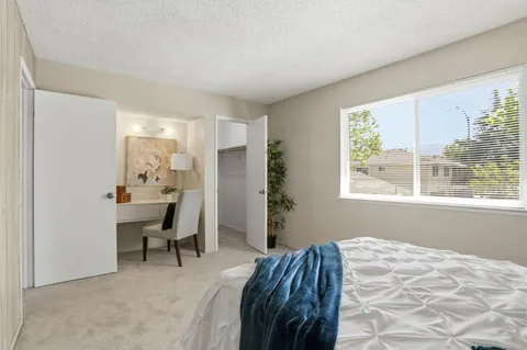 a bedroom with a bed and a window