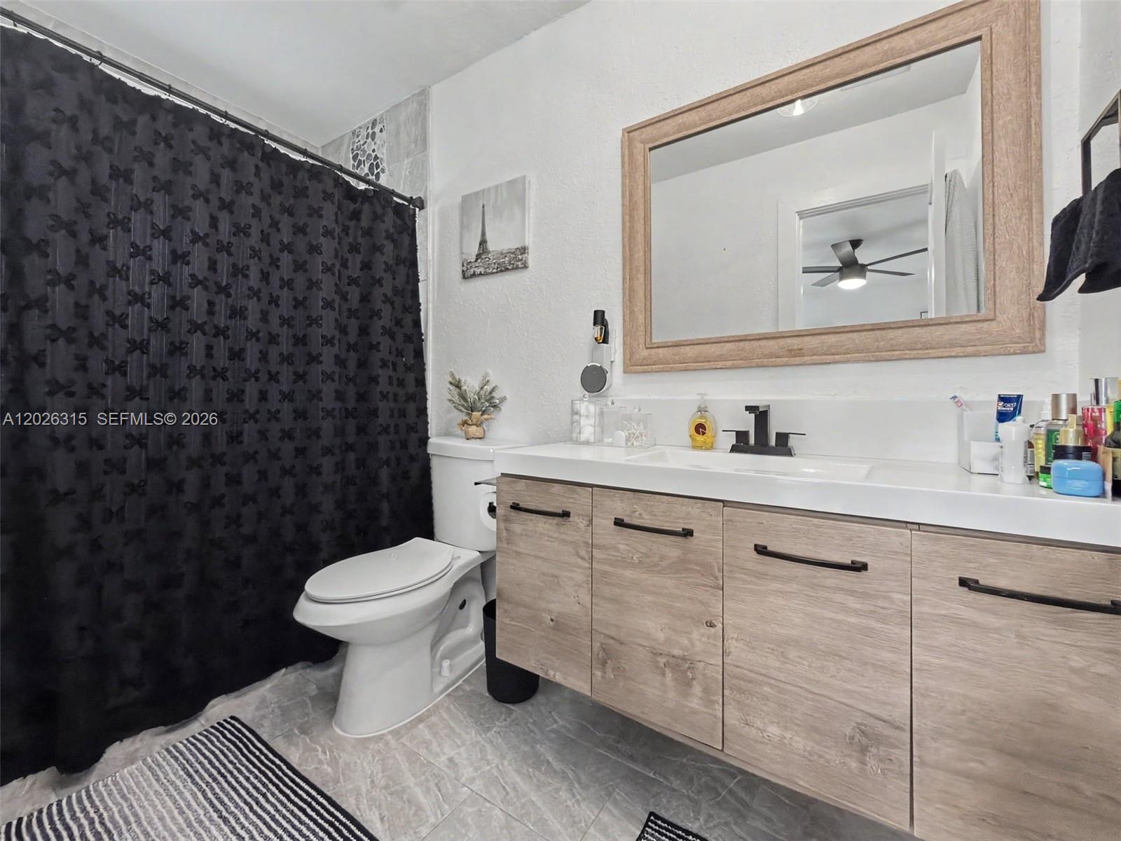 10762 Southwest 145th Street Miami, FL 33176 - Photo 18 of 28 a bathroom with a sink toilet and a mirror