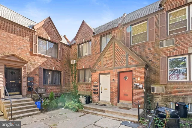 a view of a brick house with many windows